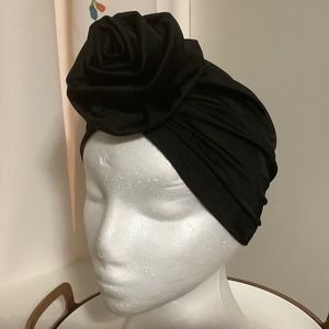 Gorgeous New in package Black stretchy turban with flower on front